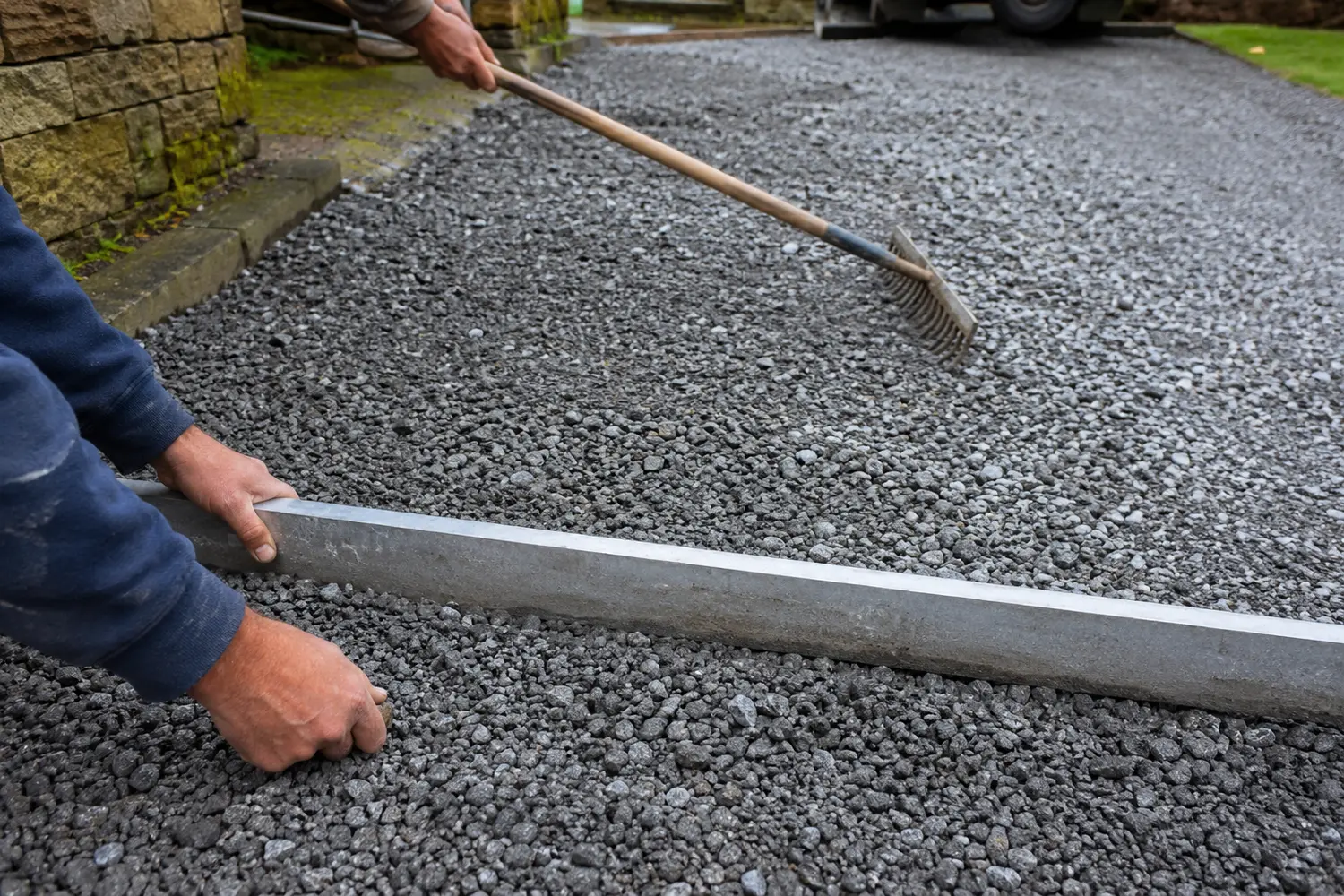 Compacted stone sub-base being laid